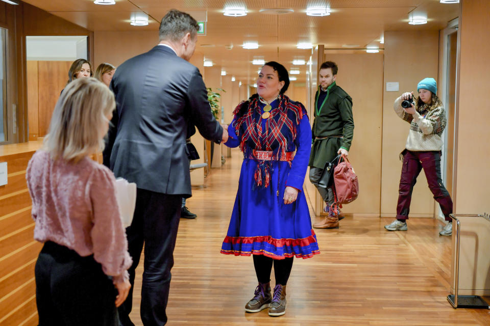 Norway's Oil and Energy Minister Terje Aasland, left, shakes hands with Sami Parliament President Silje Karine Muotka, as Norway's Agriculture and Food Minister Sandra Borch stands, left, during a meeting to follow up the Fosen Wind Farm case at the Oil and Energy Ministry in Oslo, Thursday, March 2, 2023. (Rodrigo Freitas/NTB Scanpix via AP)