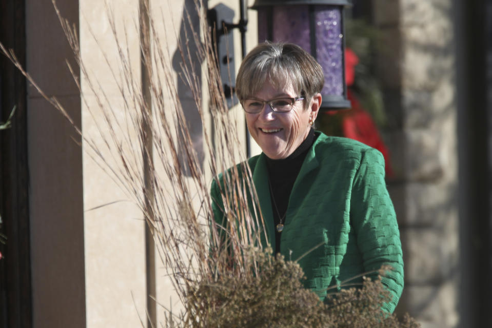 FILE- Kansas Gov. Laura Kelly Kansas Gov. Laura Kelly walks back to the front door of the governor's official residence on Nov. 23, 2021 in Topeka, Kan. The Democratic governor is facing a difficult race for reelection and is trying to appeal to moderate Republican and GOP-leaning voters who helped her win the office in 2018 (AP Photo/John Hanna)