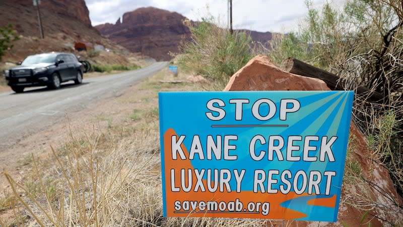 Signs are posted along Kane Creek Boulevard protesting the Kane Creek development near Moab on Friday, April 26, 2024. Developers plan to build around 580 residential and commercial units in a floodplain along the Colorado River.