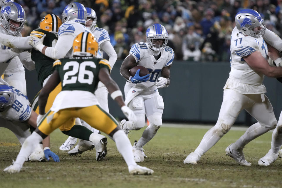 Detroit Lions running back Jamaal Williams (30) runs with the ball during the second half of an NFL football game against the Green Bay Packers Sunday, Jan. 8, 2023, in Green Bay, Wis. (AP Photo/Morry Gash)