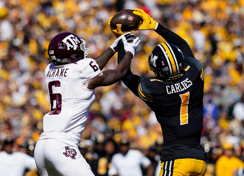 Missouri defensive back Jaylon Carlies (1) intercepts a pass intended for Texas A&M Aggies running back Devon Achane (6) during the first half Saturday at Faurot Field.