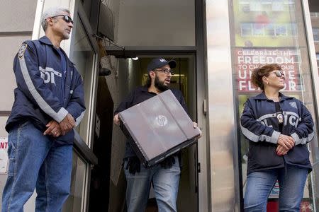 Law enforcement officers seize evidence from the Manhattan offices of Rentboy.com in New York August 25, 2015. REUTERS/Brendan McDermid