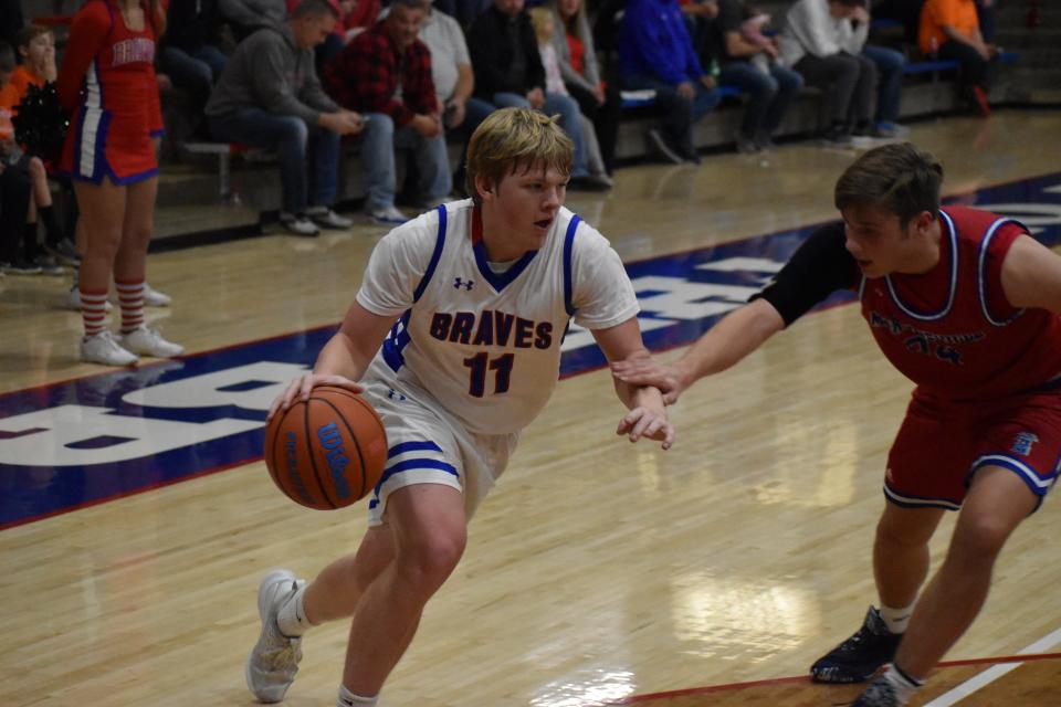 Indian Creek's Javan Crouch (11) drives the ball inside as Martinsville's Luke Cheatham trails during their game on Dec. 21, 2021.