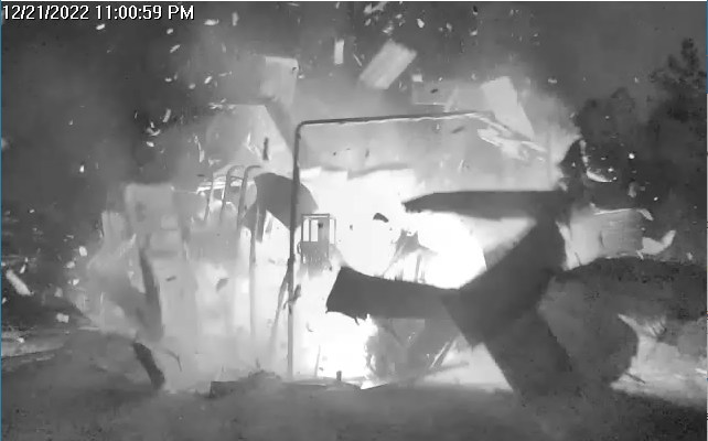  still from a black-and-white video showing a prototype space module exploding and pieces flying 