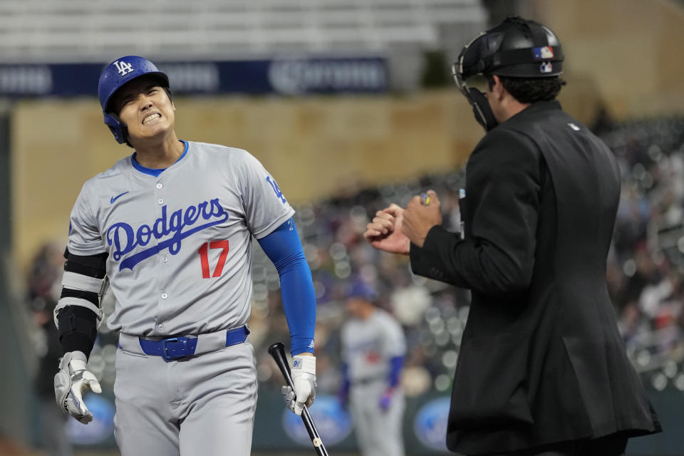 Los Angeles Dodgers designated hitter Shohei Ohtani (17) reacts toward home plate umpire John Tumpane after being called striking out while looking during the ninth inning of a baseball game against the Minnesota TwinsMonday, April 8, 2024, in Minneapolis. (AP Photo/Abbie Parr)