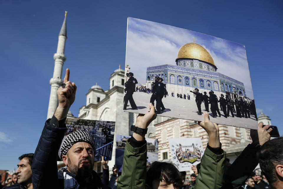 Protesters, one holding a photo of Israeli police forces outside the Dome of the Rock mosque located in east Jerusalem's Old City, chant anti-U.S. slogans during a protest against the proposed U.S. Mideast peace plan following Friday's Muslim prayers outside Fatih mosque in Istanbul, Friday, Jan. 31, 2020. U.S. President Donald Trump's Mideast plan would create a disjointed Palestinian state with a capital on the outskirts of east Jerusalem, beyond the separation barrier built by Israel. The rest of the Jerusalem, including the Old City, would remain Israel's capital. (AP Photo/Emrah Gurel)