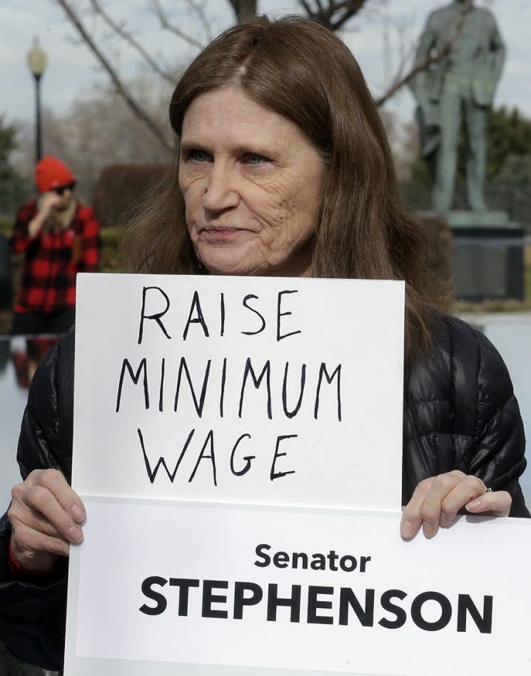 A protester holds a sign at the Utah state capitol for 