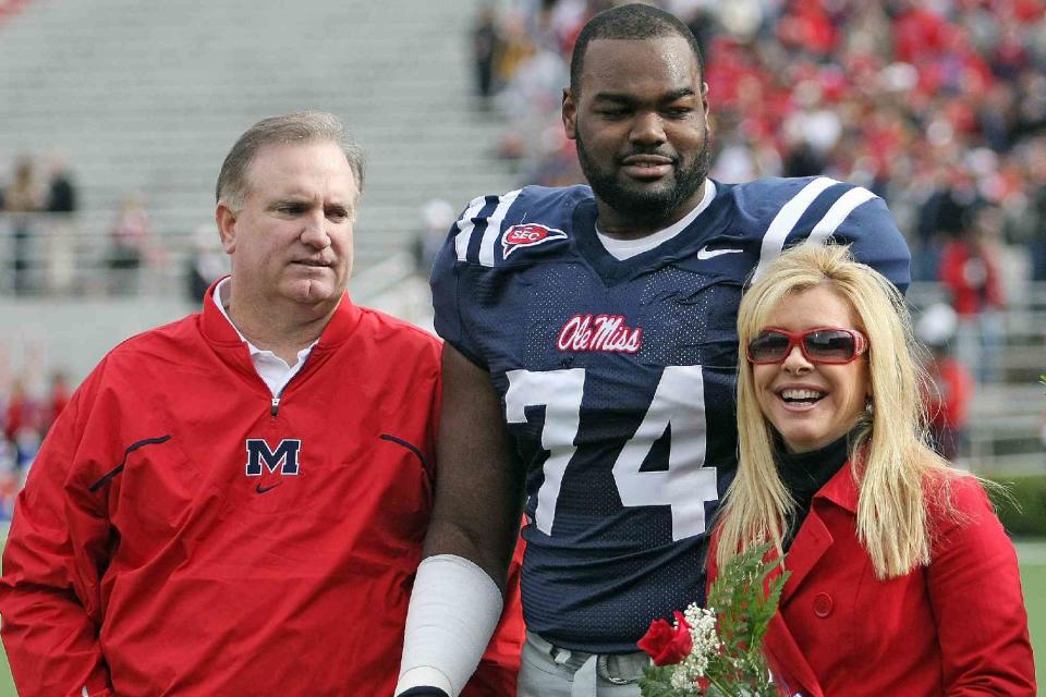 <p>Matthew Sharpe/Getty</p> From left: Sean Tuohy, Michael Oher, and Leigh Anne Tuohy