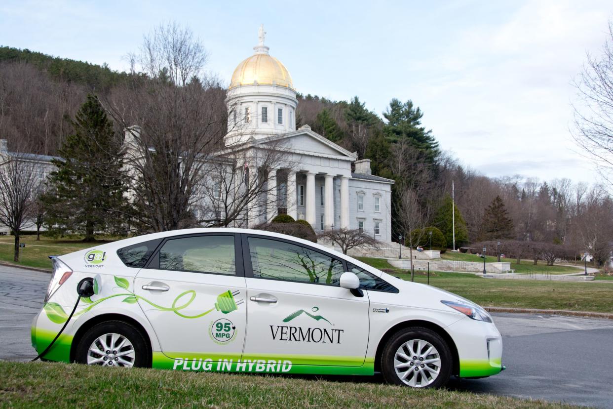 Montpelier, VT, USA - April 21, 2014: A plug-in hybrid vehicle owned by the State of Vermont is plugged in for refueling on a warm spring evening at a parking lot outside the Vermont Statehouse in Montpelier.
