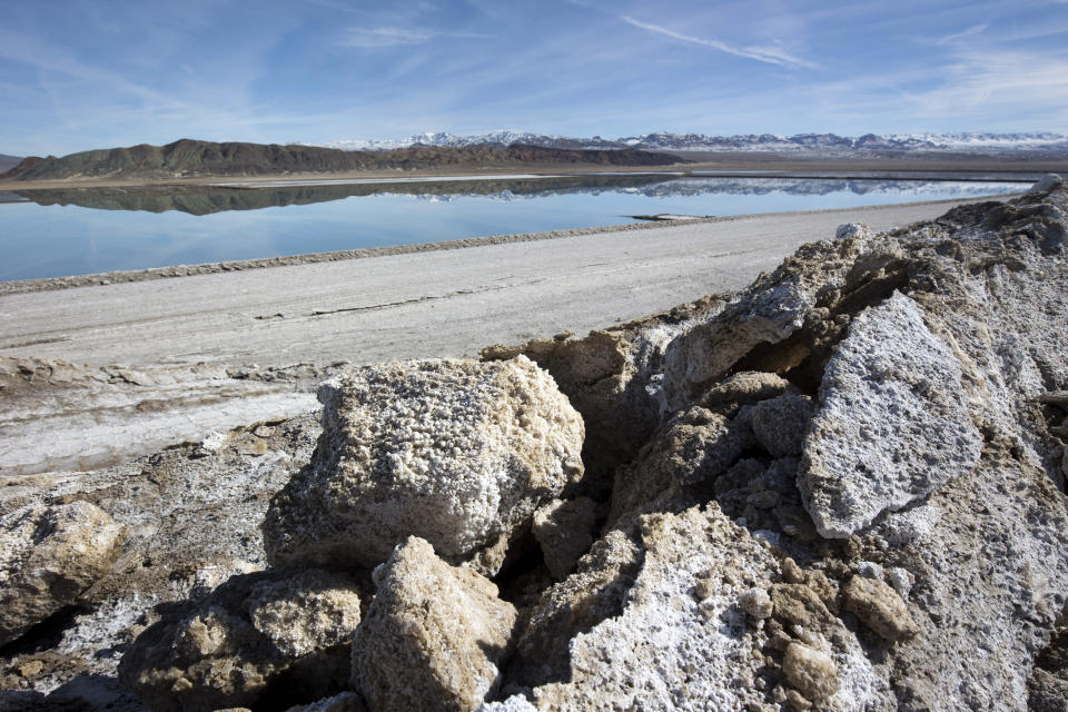 FILE - In this Jan. 30, 2017, file photo, waste salt, foreground, is shown near an evaporation pond at the Silver Peak lithium mine near Tonopah, Nev. The Trump administration granted final approval for a proposed northern Nevada lithium mine, one of several eleventh-hour moves made by the Department of Interior to greenlight mining and energy projects. Unlike some other approvals, which are likely to be revoked, President Biden has voiced support for lithium mining as part of his clean energy plans. (Steve Marcus/Las Vegas Sun via AP, File)