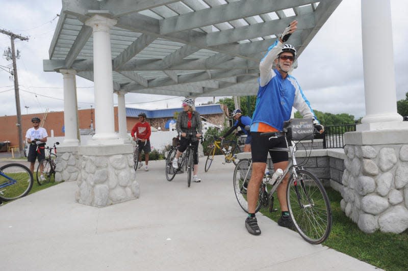 Monroe News photo by KIM BRENT 
Greg Koesel motions to other cyclists, as members of Monroe's bi-weekly bicycling club get ready to set off on their ride in 2014. The club resumes bi-weekly rides Tuesday.