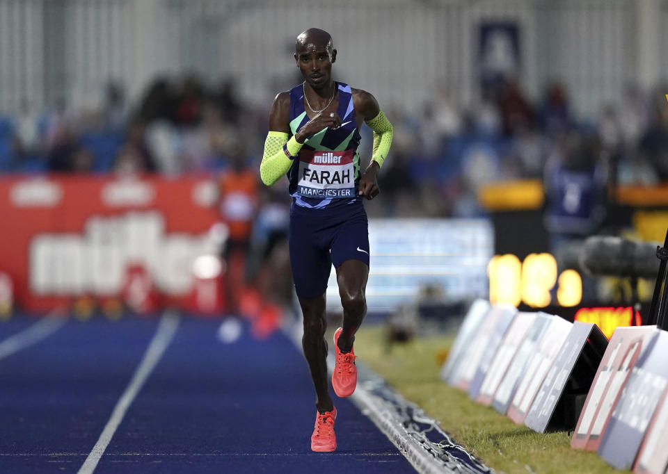 Britain's Mo Farah competes in the Men's 10000m final during day one of the British Athletics Championships at Manchester Regional Arena in England, Friday June 25, 2021. Mo Farah failed to qualify for the Tokyo Olympics and will not defend his 10,000-meter title. The four-time Olympic champion missed the qualifying time in an invitational 10,000 at the British athletics championships in Manchester. (Martin Rickett/PA via AP)