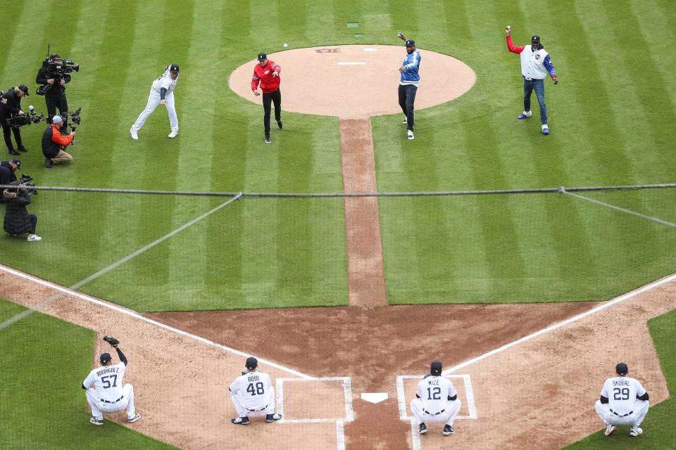 From left: Tigers designated hitter Miguel Cabrera, former Red Wings defenseman Nicklas Lidström, former Lions receiver Calvin Johnson, and former Pistons center Ben Wallace throw the ceremonial first pitch at the Tigers' home opener vs. the Red Sox at Comerica Park in Detroit on Thursday, April 6, 2023.