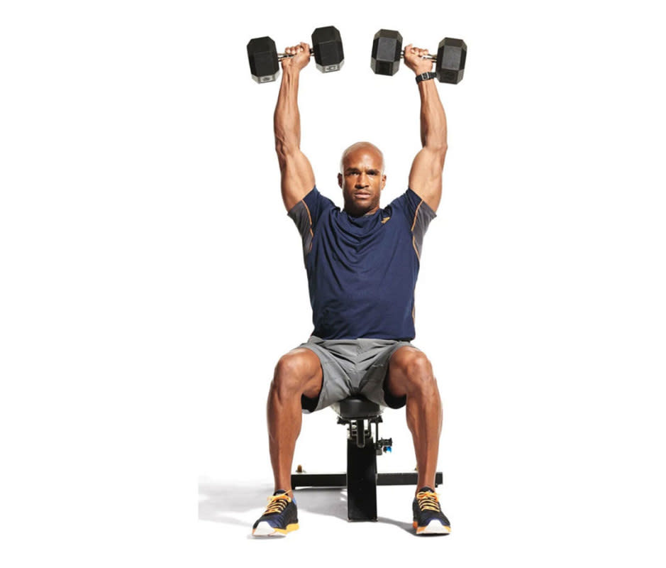 How to Do It:<ol><li>Stand or sit with feet shoulder-width apart, holding dumbbells in front of your forehead, elbows at 90 degrees and palms facing you. </li><li>Slowly open your arms wide so elbows are still at right angles but hands are now facing out, squeezing your shoulder blades together as you perform a military press (shown). </li><li>Reverse the pattern. That’s 1 rep.</li></ol>