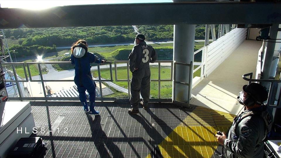 NASA’s Boeing Crew Flight Test astronauts Suni Williams and a United Launch Alliance technician stand near the crew access arm at Space Launch Complex-41 at nearby Cape Canaveral Space Force Station on Wednesday, June 5, 2024.