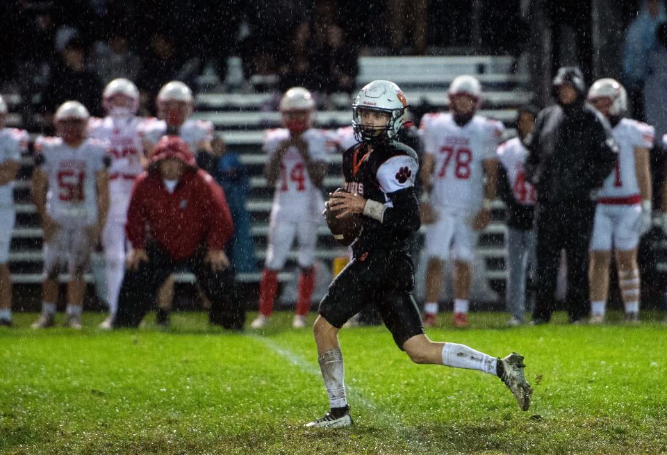 Maynard junior captain and quarterback Dylan Gallo looks for an open receiver during the game against Hudson at Alumni Field in Maynard, Sept. 29, 2023.