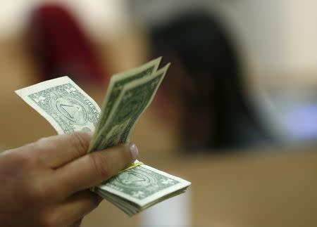 Dollar ends week higher, Powell testimony ahead