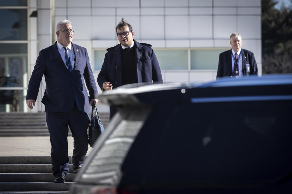 Former U.S. Rep George Santos leaves the federal courthouse with his lawyer in Central Islip, N.Y. on, Tuesday, Dec. 12, 2023, in New York. (AP Photo/Stefan Jeremiah)