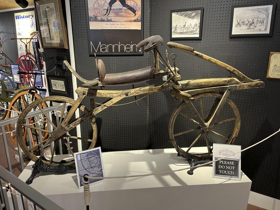 A replica of the 1816 “walking horse,” built by Karl von Drais in Germany, appears at the Bicycle Museum of America in New Bremen, Ohio on Dec. 26, 2022. The museum traces the bike's impact on culture, transportation and plain ol’ fun, showing how it became synonymous with convenience and ease. (Steve Wartenberg via AP)