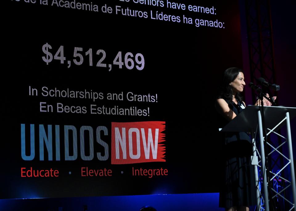 UnidosNow executive director Cintia Elenstar announces that this year's seniors collectively earned over $4.5 million in scholarships and grants.