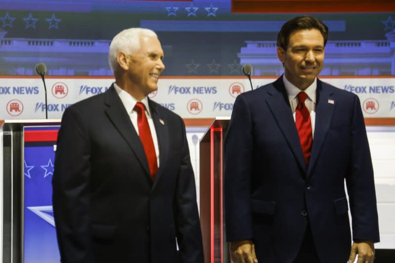 Republican presidential candidate Mike Pence (L) stands by Republican presidential candidate Ron DeSantis as they take the stage at the first Republican presidential candidate debate in Milwaukee, Wis., on Wednesday. Photo by Tannen Maury/UPI