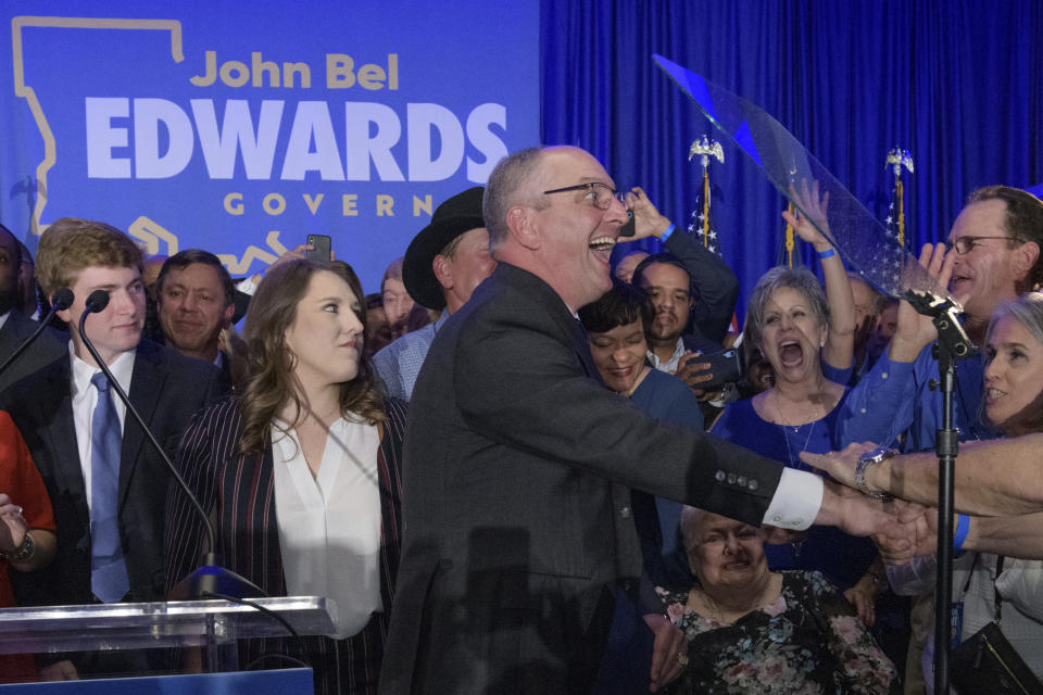 Louisiana Gov. John Bel Edwards arrives to address supporters at his election night watch party in Baton Rouge, La., Saturday, Nov. 16, 2019. (AP Photo/Matthew Hinton)