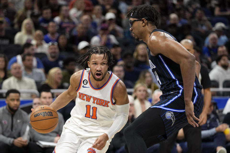 New York Knicks' Jalen Brunson (11) drives around Orlando Magic's Wendell Carter Jr. during the first half of an NBA basketball game Tuesday, Feb. 7, 2023, in Orlando, Fla. (AP Photo/John Raoux)