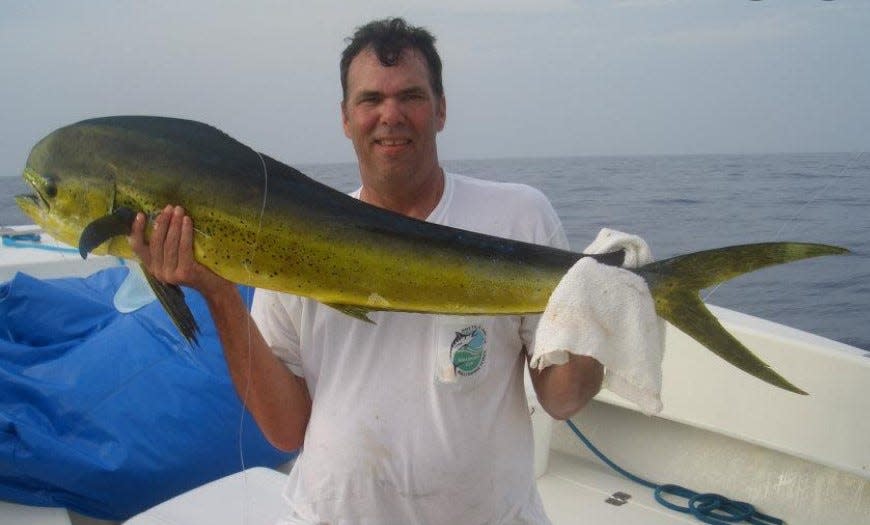 Lee Motlow holds up a recently landed mahi-mahi during a deep-sea fishing trip to the Bahamas in this photo from 2012. Motlow, who co-founded one of the Augusta area's best-known barbecue joints, died Aug. 30 at age 63.