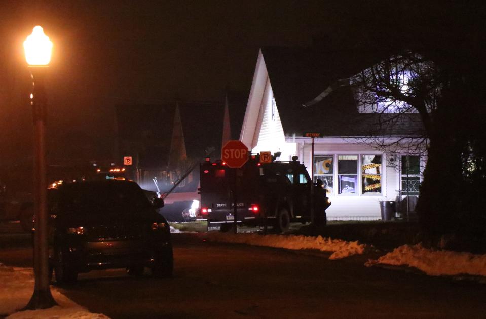 Michigan State Police illuminate a house on Mechanic Street in Sturgis and issue commands to surrender to a man who was wanted on felony charges Monday, March 6, 2023.