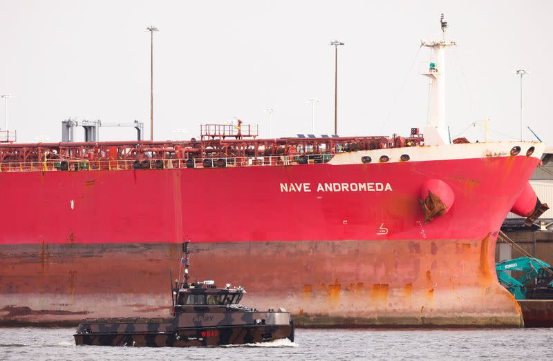 A military boat passes in front of the Liberia-flagged oil tanker Nave Andromeda at Southampton Docks, following a security incident aboard the ship the night before off the coast of Isle of Wight, in Southampton