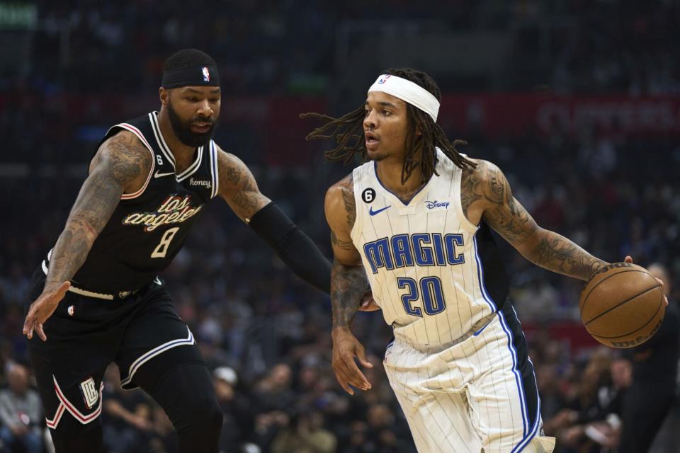 Orlando Magic guard Markelle Fultz controls the ball in front of Clippers forward Marcus Morris Sr.