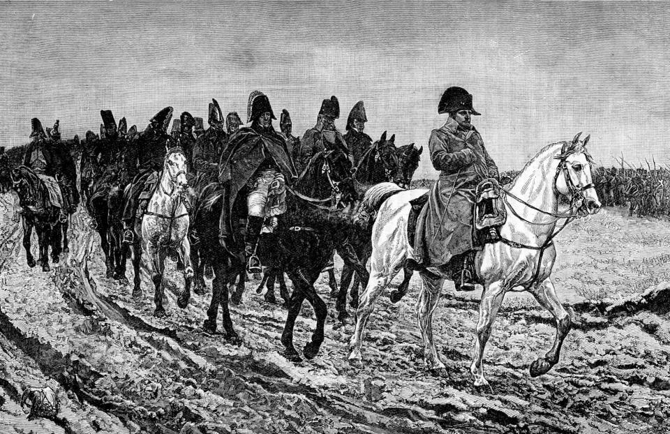 An etching of Napoleon on a white horse leading his army into Russia.