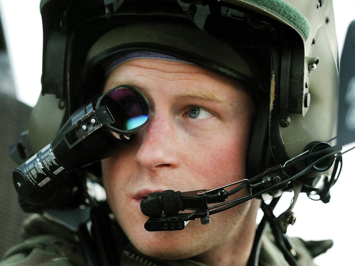 Prince Harry wears his monocle gun sight as he sits in the front seat of his Apache helicopter: JOHN STILLWELL/AFP/Getty Images