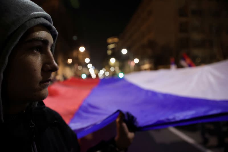 People hold giant Serbian flag during a protest against the Serbian authorities and French-German plan for the resolution of Kosovo