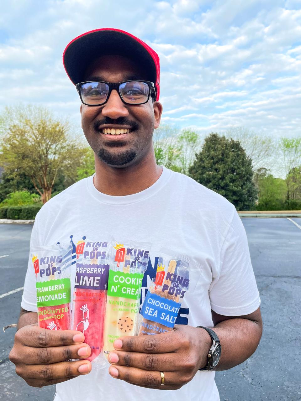 King of Pops franchise co-owner Brian Joseph is shown in this photo taken in Athens, Ga., on April 7, 2022. In the past week, Joseph and his wife, Taylor, began selling their popsicles at the Athens Farmers Market and the University of Georgia's Tate Student Center.