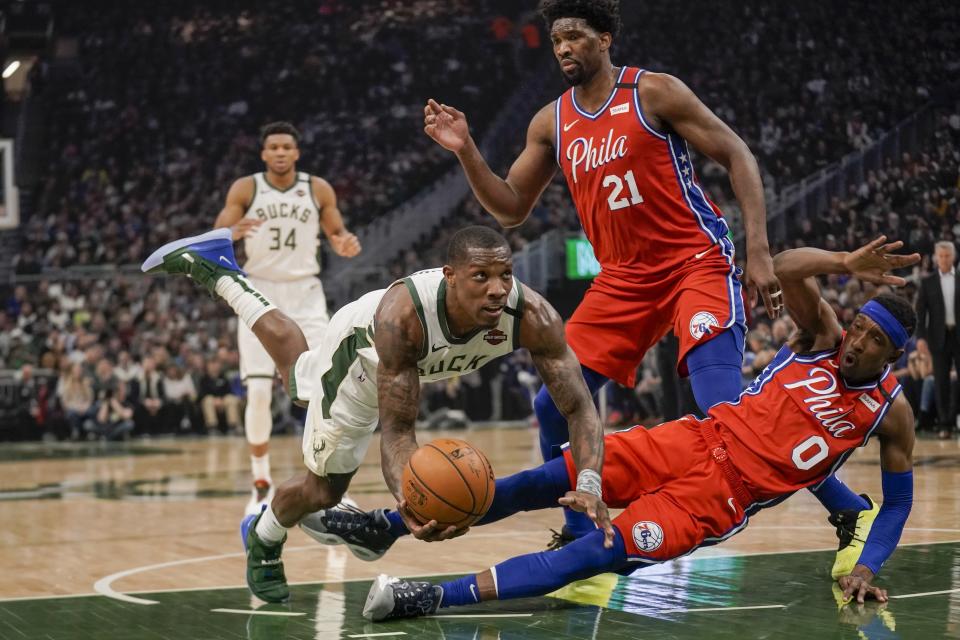 Milwaukee Bucks' Eric Bledsoe is called for a charge on Philadelphia 76ers' Josh Richardson during the first half of an NBA basketball game Saturday, Feb. 22, 2020, in Milwaukee. (AP Photo/Morry Gash)