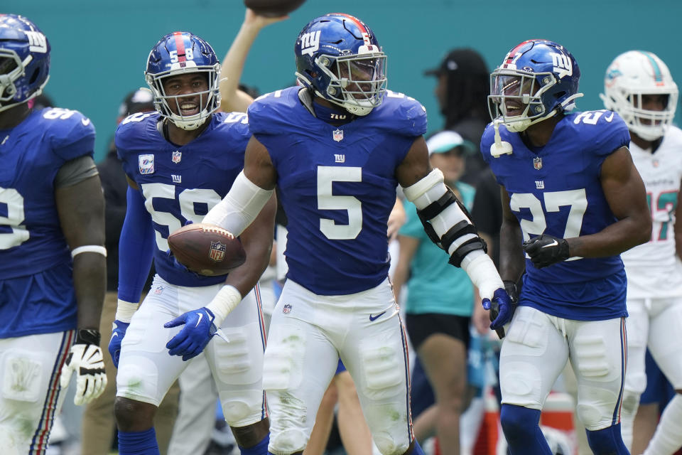 New York Giants linebacker Kayvon Thibodeaux (5) celebrates after recovering a fumble Miami Dolphins running back De'Von Achane (28) during the first half of an NFL football game, Sunday, Oct. 8, 2023, in Miami Gardens, Fla. (AP Photo/Wilfredo Lee)