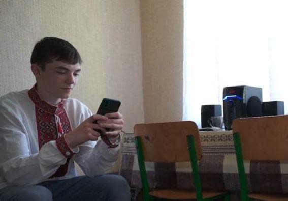 Ivan, 16, a Ukrainian orphan who was rescued after being taken against his will to Russia by Russian forces, messages a friend who is still in Russia from his dorm room in the western Ukrainian city of Khmelnytskyi. / Credit: CBS News