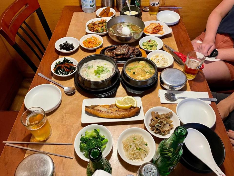 A collection of banchan and main dishes at Pine Tree House.