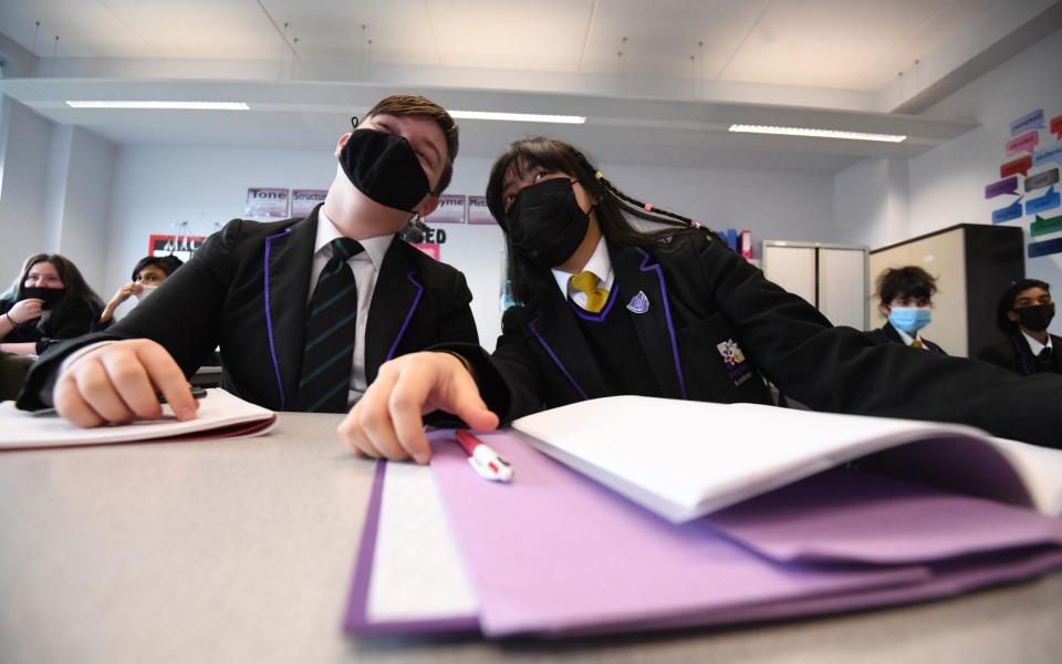 Children wearing facemasks during a lesson at Hounslow Kingsley Academy in West London, as pupils in England returned to school for the first time in two months in March - Kirsty O'Connor/PA Wire