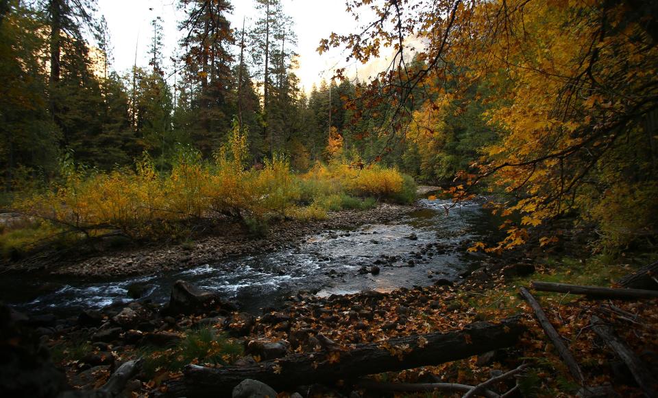 Merced is shown winding through Yosemite Valley while fall colors begin to turn.