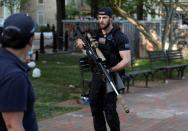 Secret Service sniper carries weapon as U.S. President Trump holds photo opportunity in front of St John's Church in Washington