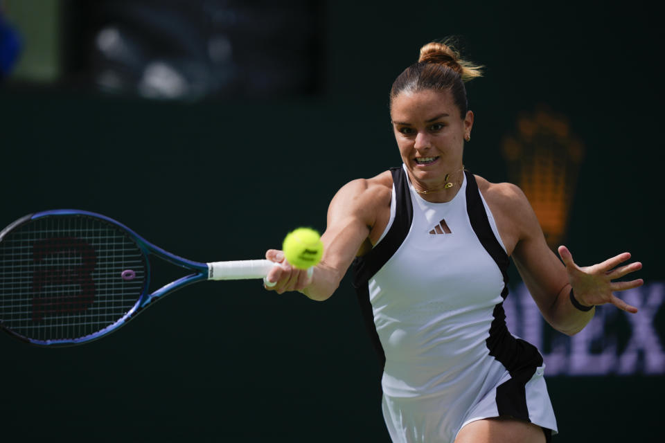 Maria Sakkari, of Greece, returns to Iga Swiatek, of Poland, during the final match at the BNP Paribas Open tennis tournament, Sunday, March 17, 2024, in Indian Wells, Calif. (AP Photo/Ryan Sun)