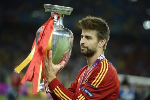 Spanish defender Gerard Pique holds the trophy after winning the Euro 2012 football championships final match Spain vs Italy at the Olympic Stadium in Kiev. Spain won 4-0