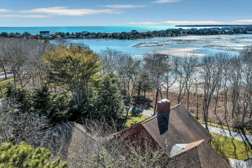 This stunning Barnstable home is located on the Centerville River and offers incredible water views.