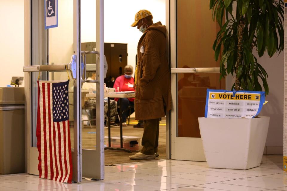 Doors are propped open as election workers wait inside