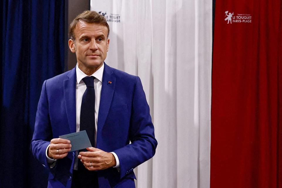 France's President Emmanuel Macron leaves the polling booth prior to cast his vote in the first round of parliamentary elections at a polling station in Le Touquet, northern France (POOL/AFP via Getty Images)