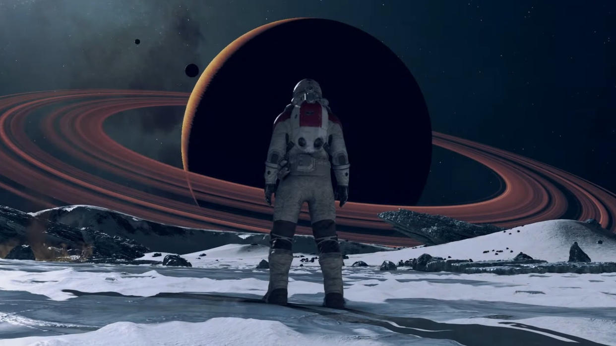  An astronaut staring at a distant ringed planet in Starfield 