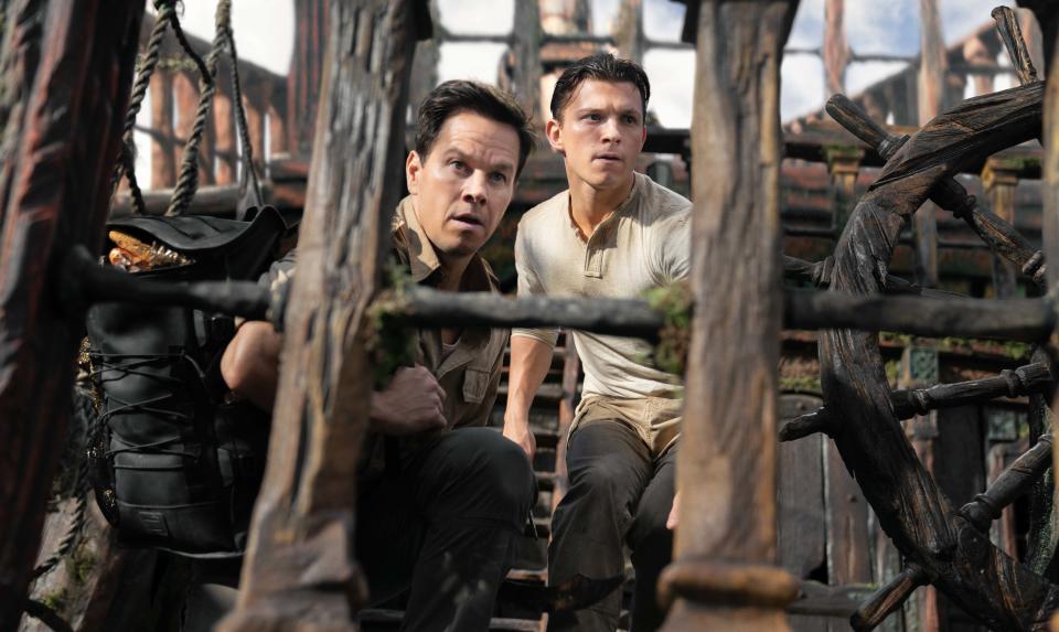 From left, Mark Wahlberg and Tom Holland in Columbia Pictures’ ‘Uncharted.’ - Credit: Columbia Pictures/Sony Pictures