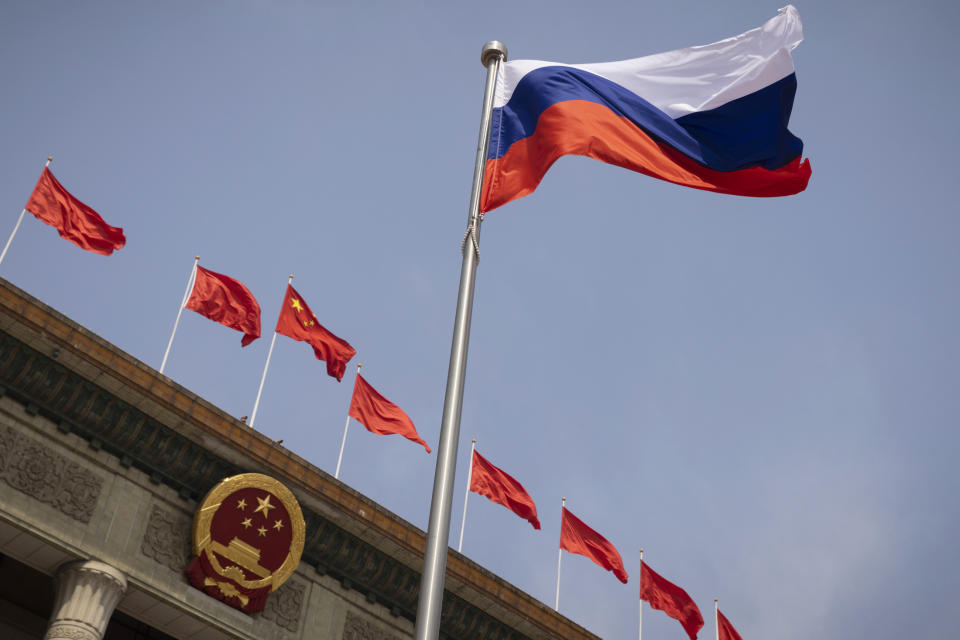The Russian national flag flies in front of the Great Hall of the People before a welcoming ceremony for Russian Prime Minister Mikhail Mishustin in Beijing, China, Wednesday, May 24, 2023. (Thomas Peter/Pool Photo via AP)